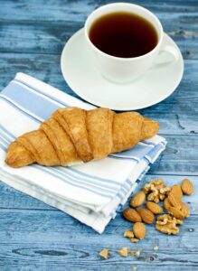 croissant cup of coffe almod and nuts