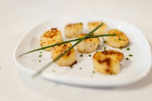 seared scalops served in a plate