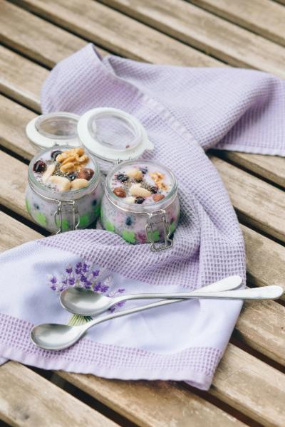 two jars of chia pudding garnished with berries and almond