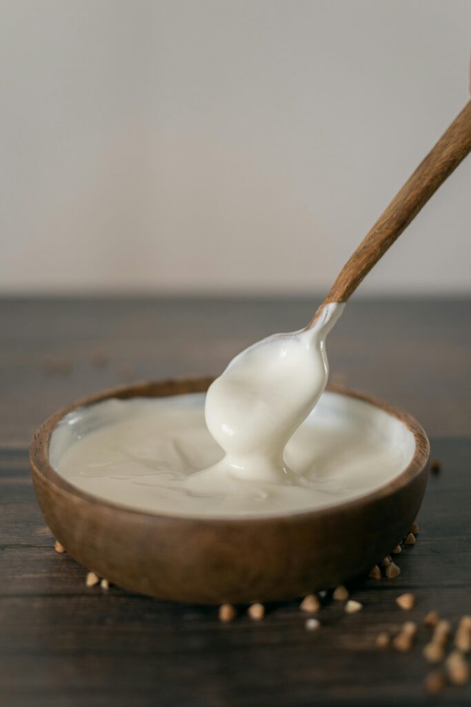 Crème Fraîche in a Wooden Bowl with a Spoon