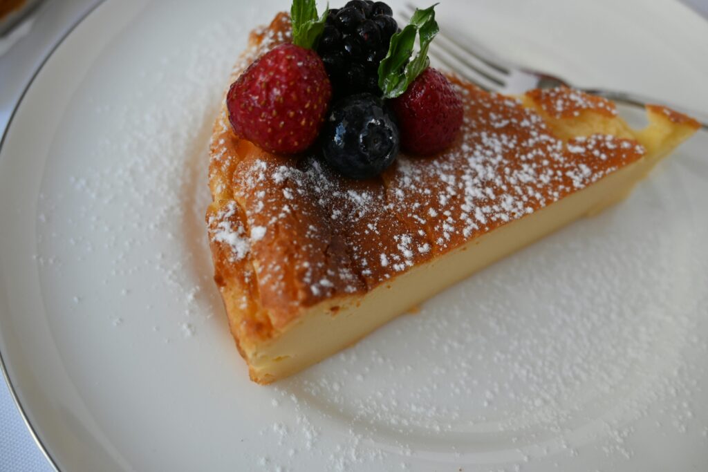 French Toast souffle garnished with berries in a white plate