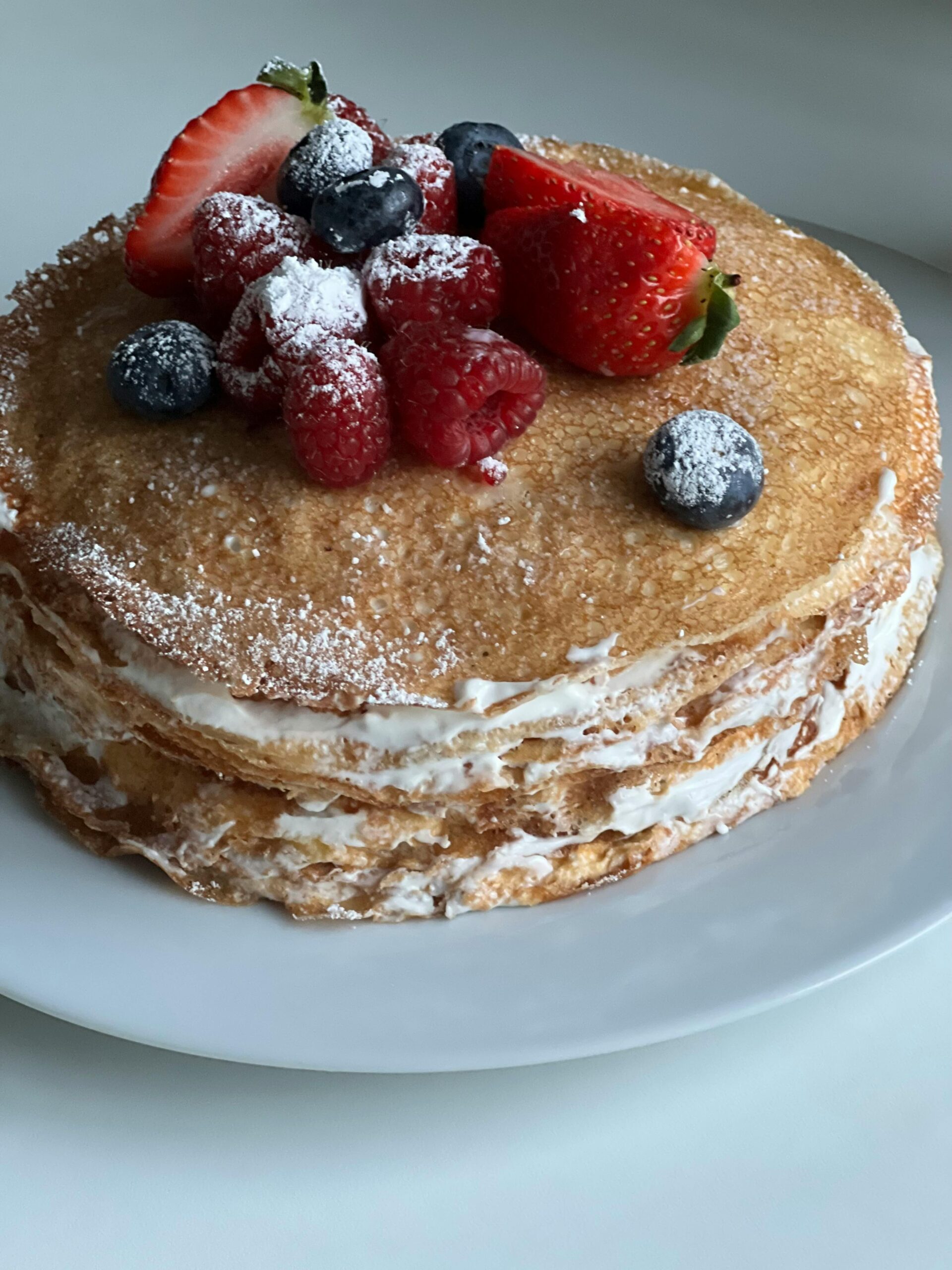 French toast souffle with cardamom cream garnished with berries