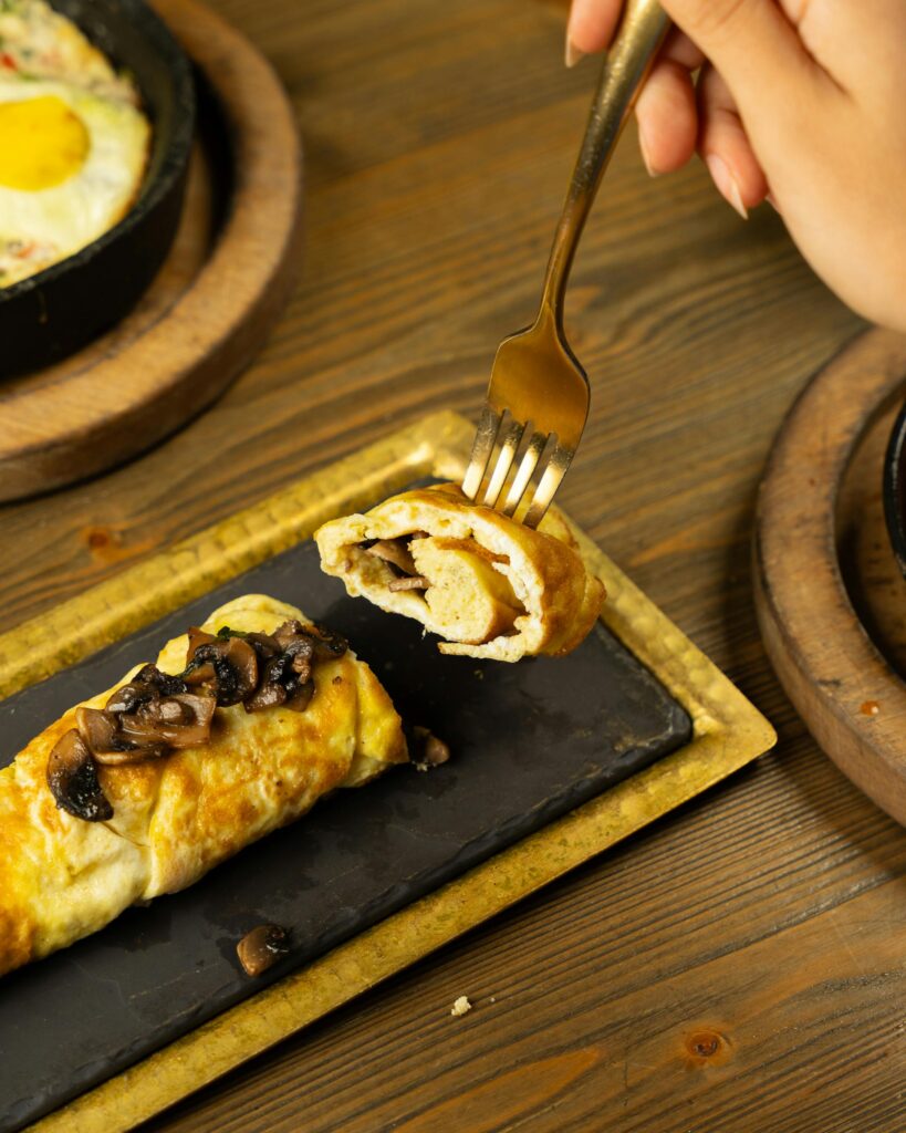 Puff Pastry filled with Mushrooms with a Fork taking a piece of it