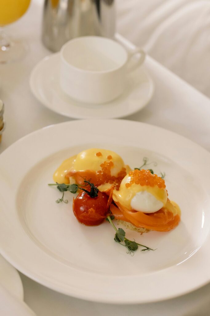 Poached Eggs with Caviar Garnished With Herb And Contrasted With a Small Tomato