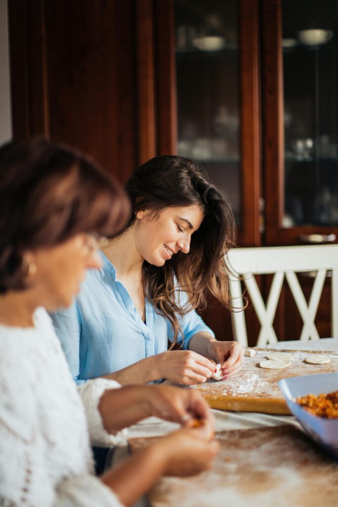 Two Women Sealinh Pumpkin Ravioli