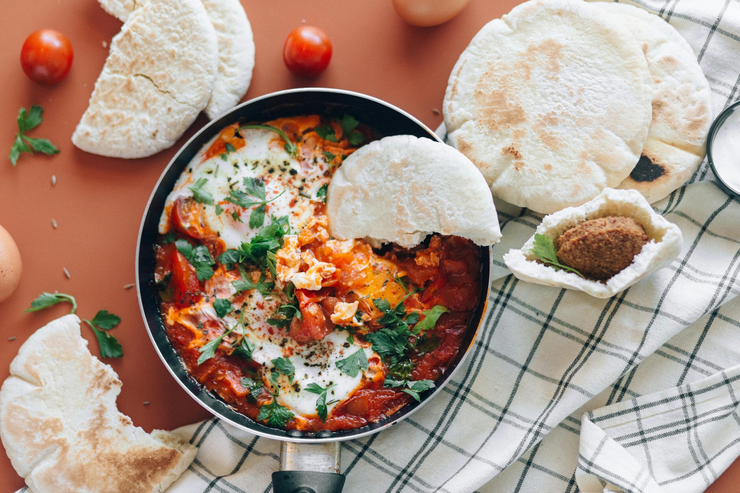 Shakshuka with Feta and Sumac in a Pan on Wooden Table