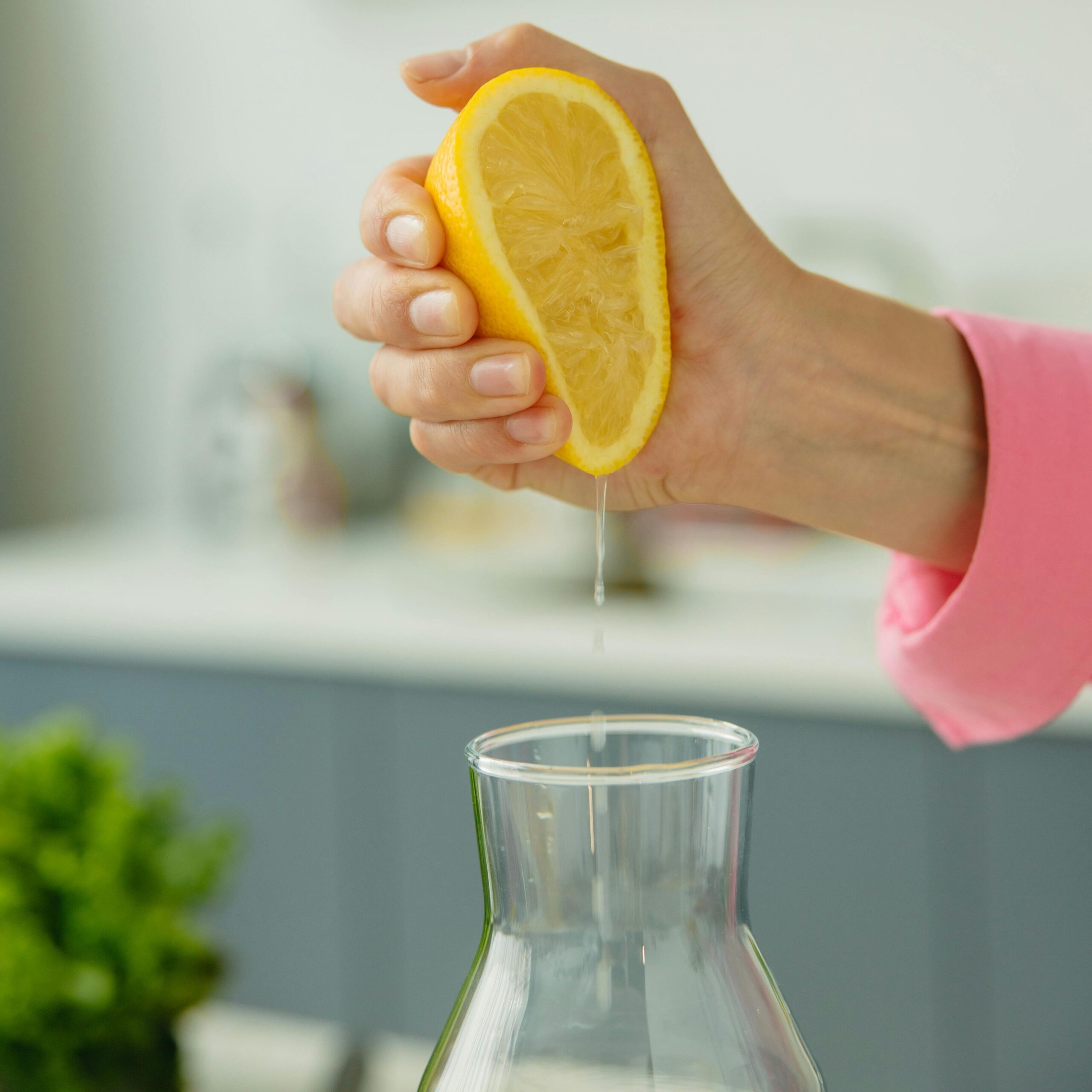 a female hand squeezing  lemon juice