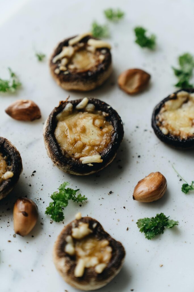 Stuffed Portobello Mushrooms with cloves of garlich and garnished with herbs