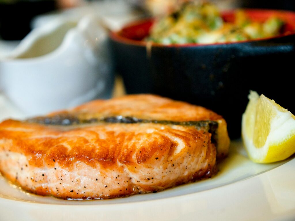 salmon smoked with a bowl of salam and a slice of lemon 