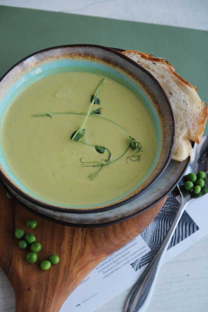 Pea soup in a plate with a slice of bread 