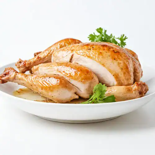 A perfectly roasted whole chicken, golden and juicy, sliced to reveal tender meat, garnished with fresh parsley and served on a white plate.