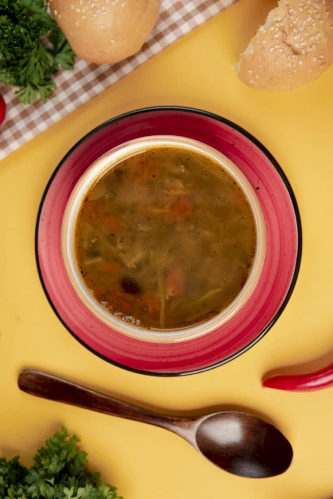 Warm Bowl of Cabbage and Vegetable Soup with Fresh Bread