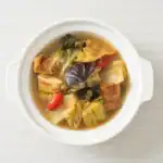 Bowl of Hearty Cabbage and Vegetable Soup with Mushrooms and Chili