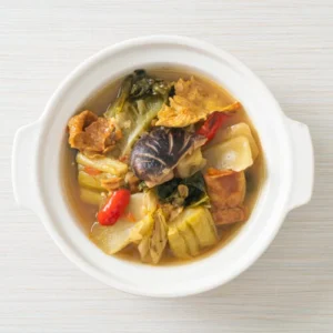 Bowl of Hearty Cabbage and Vegetable Soup with Mushrooms and Chili