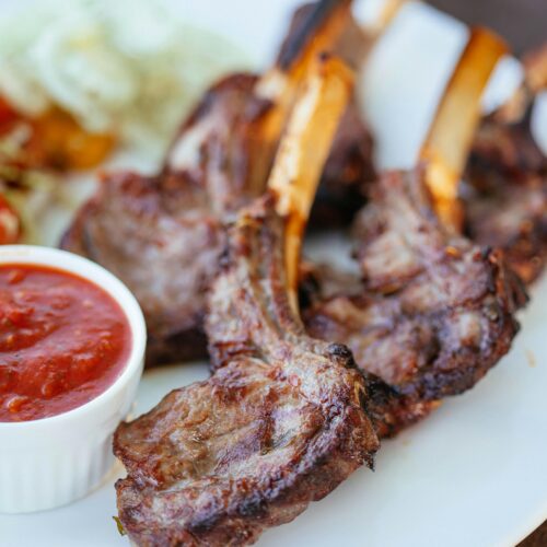 seared lamb chops in a white plate