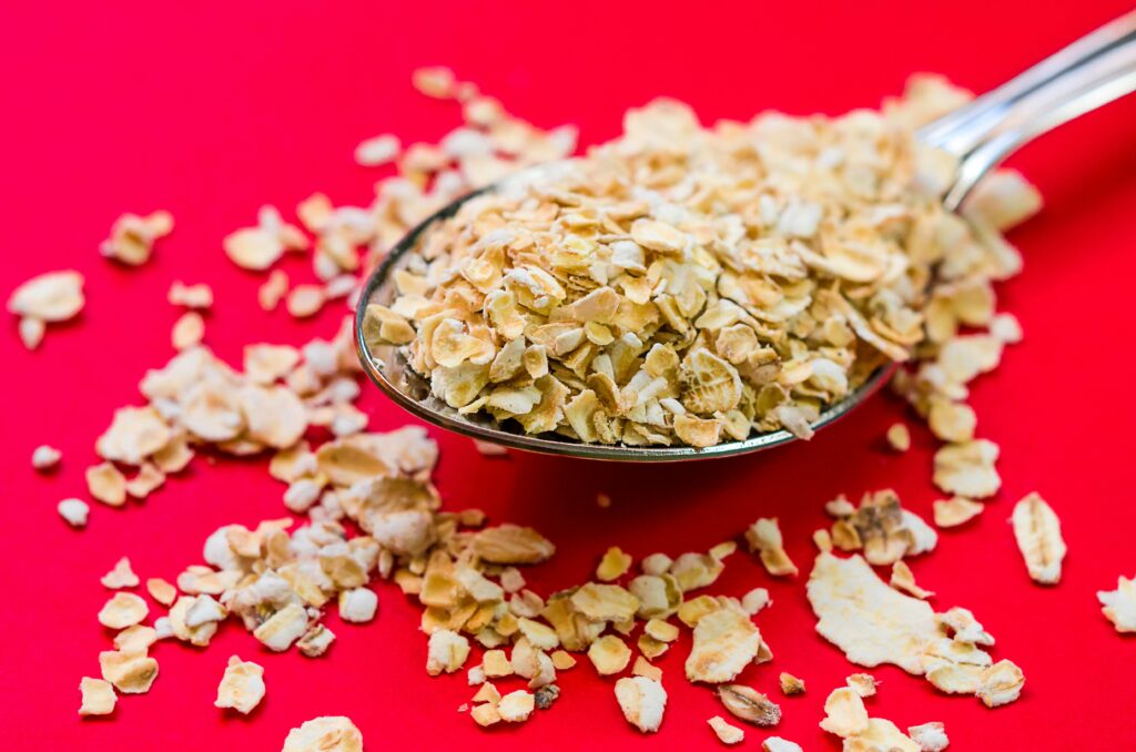 oats in a spoon with red background