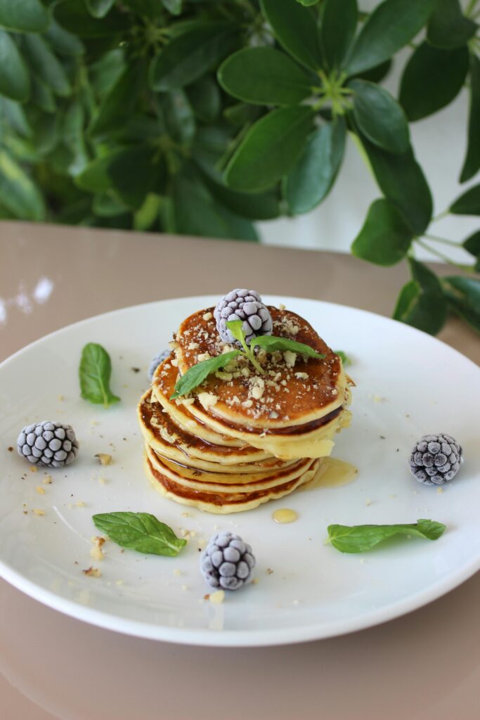 pancake garnished with mint in a white plate