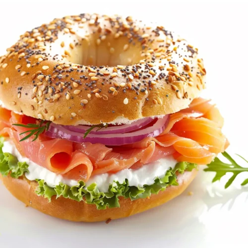 Sesame bagel filled with smoked salmon, cream cheese, red onion, and lettuce.