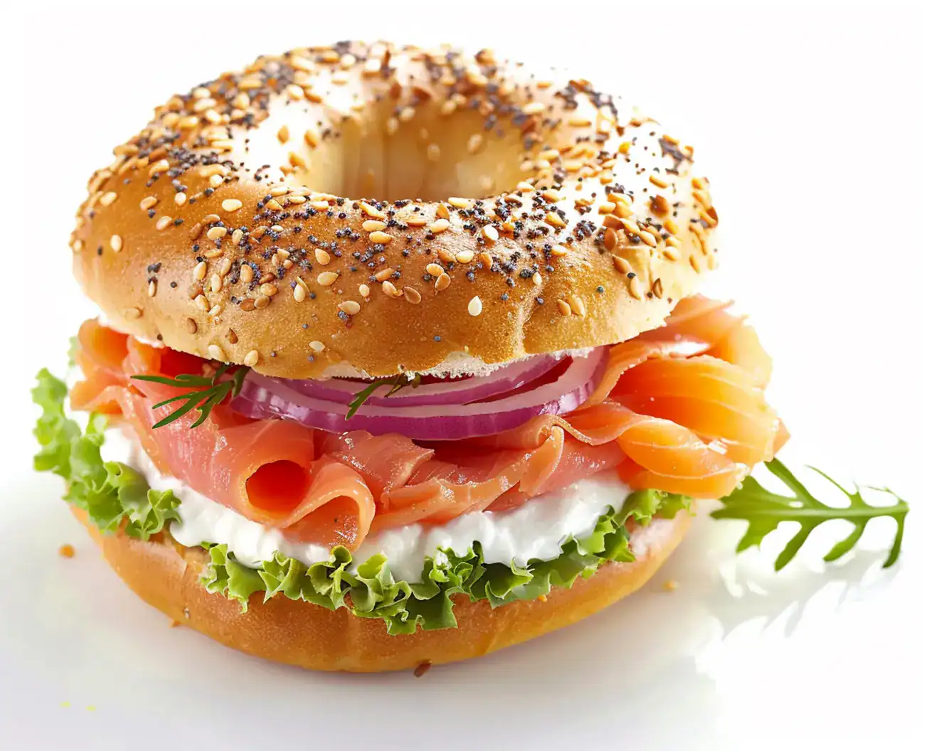 Sesame bagel filled with smoked salmon, cream cheese, red onion, and lettuce.