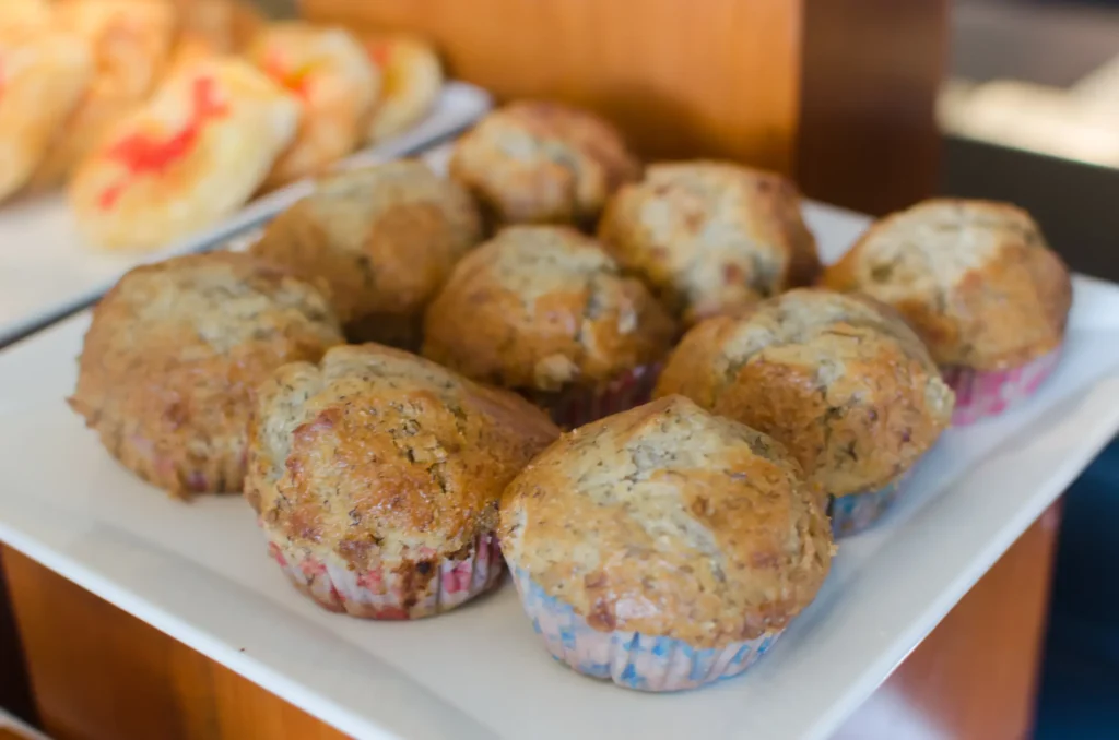 A close-up of freshly baked banana oatmeal muffins on a white plate, perfect for a healthy snack or breakfast treat.