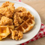 chicken and waffles in a white plate