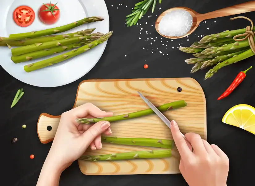 Hands trimming fresh asparagus on a cutting board with tomatoes, lemon, and salt nearby.