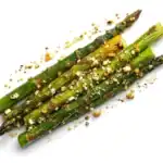 Roasted asparagus spears topped with garlic, Parmesan cheese, and toasted seasoning.