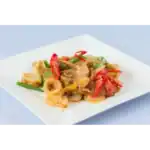 Plate of crispy stir-fried squid with vegetables and red chili slices on a white square dish.