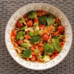 Colorful tuna pasta salad with broccoli, cherry tomatoes, bell pepper, and fresh basil