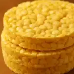 Close-up of stacked golden corn cakes showing their puffed texture and crispy surface