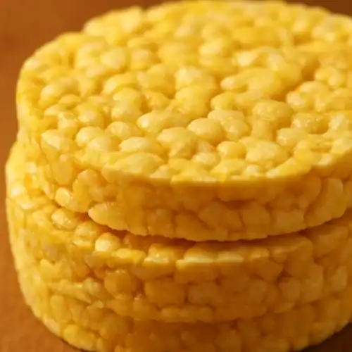 Close-up of stacked golden corn cakes showing their puffed texture and crispy surface