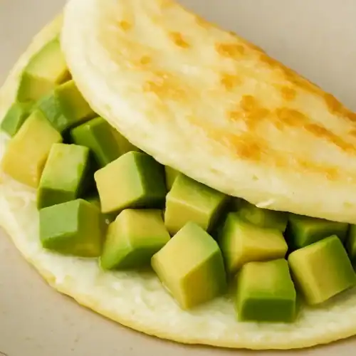Close-up of an avocado and egg white veggie omelette on a plate