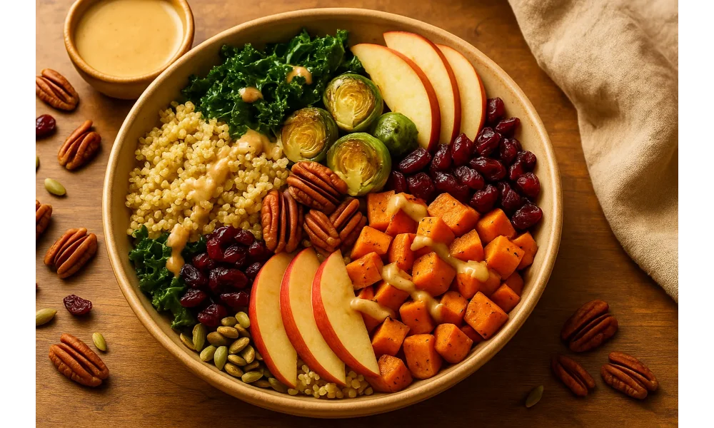 Warm harvest grain bowl with quinoa, roasted sweet potatoes, kale, Brussels sprouts, apple slices, cranberries, pecans, pumpkin seeds, and maple-tahini drizzle.